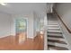 Bright living room featuring hardwood floors, neutral walls, and staircase access at 3614 Kilgo Dr, Durham, NC 27705