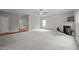 Expansive living room with a fireplace, hardwood flooring, and multiple windows offering natural light at 3614 Kilgo Dr, Durham, NC 27705