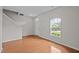 Spacious living room with hardwood floors, neutral walls, and a staircase to the upper level at 3614 Kilgo Dr, Durham, NC 27705