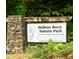 Hollow Rock Nature Park sign, a Durham/Orange County Partnership with lush surroundings at 3614 Kilgo Dr, Durham, NC 27705