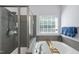 The bathroom has a large soaking tub, a window for natural light, and a frameless shower door at 3621 Colby Chase Dr, Apex, NC 27539
