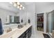 This primary bathroom has a double sink vanity, walk-in shower, and linen closet at 3621 Colby Chase Dr, Apex, NC 27539