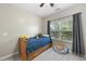 This bedroom offers a twin bed, natural light from a window, and neutral paint and carpet at 3621 Colby Chase Dr, Apex, NC 27539
