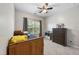 Bedroom with twin bed, ceiling fan, window with backyard view, and dresser with TV and toys at 3621 Colby Chase Dr, Apex, NC 27539