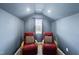 Upstairs bonus room with vaulted ceilings, natural light, and two comfortable armchairs at 3621 Colby Chase Dr, Apex, NC 27539