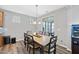 Dining room features wood table, six chairs, sliding door to patio, and chandelier lighting at 3621 Colby Chase Dr, Apex, NC 27539