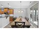 Dining room features wood table, six chairs, sliding door to patio, and chandelier lighting at 3621 Colby Chase Dr, Apex, NC 27539