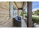 Inviting covered front porch with stone accents and comfortable seating, perfect for relaxing outdoors at 3621 Colby Chase Dr, Apex, NC 27539