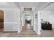 Bright hallway with arched doorways, crown molding, and hardwood floors, providing an open and airy feel at 3621 Colby Chase Dr, Apex, NC 27539