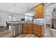 Kitchen featuring stainless appliances, granite counters, and an open view to the living room at 3621 Colby Chase Dr, Apex, NC 27539