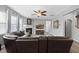 Inviting living room featuring a fireplace, large sectional sofa, ceiling fan, and wood floors at 3621 Colby Chase Dr, Apex, NC 27539