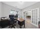 Bright home office with a large desk, a window for natural light, and built-in storage cabinets at 3621 Colby Chase Dr, Apex, NC 27539