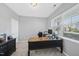 Bright home office with a large desk, a window for natural light, and built-in storage cabinets at 3621 Colby Chase Dr, Apex, NC 27539