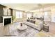 Open concept living space with fireplace, modern finishes, and seamless flow into the kitchen and dining area at 37 Mossman Ct, Zebulon, NC 27597