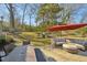 Serene backyard with lush lawn, patio seating area, and umbrella offering a perfect outdoor retreat at 3719 Hermine St, Durham, NC 27705
