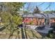 Spacious backyard featuring a patio with outdoor seating, adjacent to a well-maintained brick home at 3719 Hermine St, Durham, NC 27705