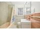Well-lit bathroom features a tub, window, and colorful shower curtain at 3719 Hermine St, Durham, NC 27705