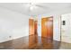 Bedroom featuring hardwood floors, closet, and an attached bathroom at 3719 Hermine St, Durham, NC 27705