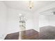 View of kitchen and dining room, with light fixture and hardwood floors at 3719 Hermine St, Durham, NC 27705