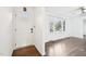 Bright entryway and hardwood floors with ample natural light from the window at 3719 Hermine St, Durham, NC 27705