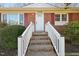 Close up of the brick steps leading to the front door and white railing at 3719 Hermine St, Durham, NC 27705