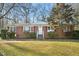 Charming brick home with red shutters and a well-manicured lawn at 3719 Hermine St, Durham, NC 27705