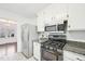 Modern kitchen with stainless steel appliances, granite countertops and white cabinets at 3719 Hermine St, Durham, NC 27705