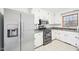 Kitchen with stainless steel refrigerator, gas range, and granite countertops at 3719 Hermine St, Durham, NC 27705