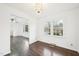 Cozy living room with hardwood floors, stylish light fixture, and connection to dining area at 3719 Hermine St, Durham, NC 27705