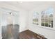 Bright living room with beautiful hardwood floors and a large window at 3719 Hermine St, Durham, NC 27705