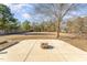 Large backyard features a concrete patio and a built-in fire pit, perfect for entertaining at 38 Colonial Hills Dr, Lillington, NC 27546