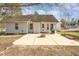 Home's backyard features a concrete patio, fire pit and a lush lawn, great for outdoor living at 38 Colonial Hills Dr, Lillington, NC 27546