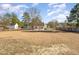 Expansive backyard showcasing the home and patio space, offering plenty of room to enjoy at 38 Colonial Hills Dr, Lillington, NC 27546