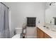 Bathroom featuring a single sink vanity with cabinet and mirror, gray walls and a toilet at 38 Colonial Hills Dr, Lillington, NC 27546