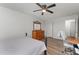 Neutral bedroom with wood floors, a dark ceiling fan, bed with gray comforter and a wood dresser at 38 Colonial Hills Dr, Lillington, NC 27546