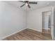 Bedroom with wood floors, neutral walls, ceiling fan and a view to an adjacent bathroom at 38 Colonial Hills Dr, Lillington, NC 27546