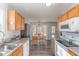 Traditional style kitchen with wood cabinets, white appliances and a view to the eat in dining area at 38 Colonial Hills Dr, Lillington, NC 27546