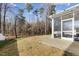 Flat backyard with patio and screened-in porch, surrounded by bare trees at 3800 Cross Timber Ln, Raleigh, NC 27603