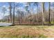 A large fenced backyard features grass and trees surrounding the perimeter at 3800 Cross Timber Ln, Raleigh, NC 27603