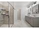 Well-lit bathroom with glass-enclosed shower, neutral tile, and double vanity at 3800 Cross Timber Ln, Raleigh, NC 27603