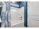 Full tub and shower with blue shower curtain at 3800 Cross Timber Ln, Raleigh, NC 27603
