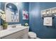 Stylish powder room featuring a charming mirror, decorative elements, and storage shelf at 3800 Cross Timber Ln, Raleigh, NC 27603