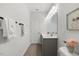 Contemporary bathroom with dual sinks, sleek vanity, modern lighting, and tile flooring at 3800 Cross Timber Ln, Raleigh, NC 27603