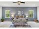 Bright bedroom with blue accent wall, ceiling fan, and natural light from two windows at 3800 Cross Timber Ln, Raleigh, NC 27603