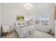 Comfortable bedroom with a large window, featuring a cozy bed, chair, and artful decor elements at 3800 Cross Timber Ln, Raleigh, NC 27603