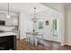Bright dining area with a modern chandelier, a table set for six, and backyard access at 3800 Cross Timber Ln, Raleigh, NC 27603