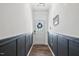Inviting entryway with paneled walls, a decorative wreath, and wood-look flooring at 3800 Cross Timber Ln, Raleigh, NC 27603