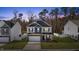 Two-story home with white siding, a gray roof, a two car garage, and well-manicured lawn at 3800 Cross Timber Ln, Raleigh, NC 27603