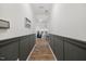 Long hallway with paneled walls, leading to a view of the living room and kitchen at 3800 Cross Timber Ln, Raleigh, NC 27603
