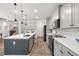 Modern kitchen boasts a large island with pendant lighting and stainless-steel appliances at 3800 Cross Timber Ln, Raleigh, NC 27603
